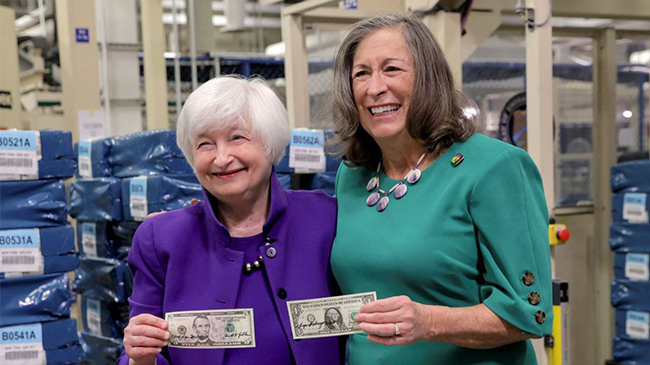 Signatures of two women on the dollar